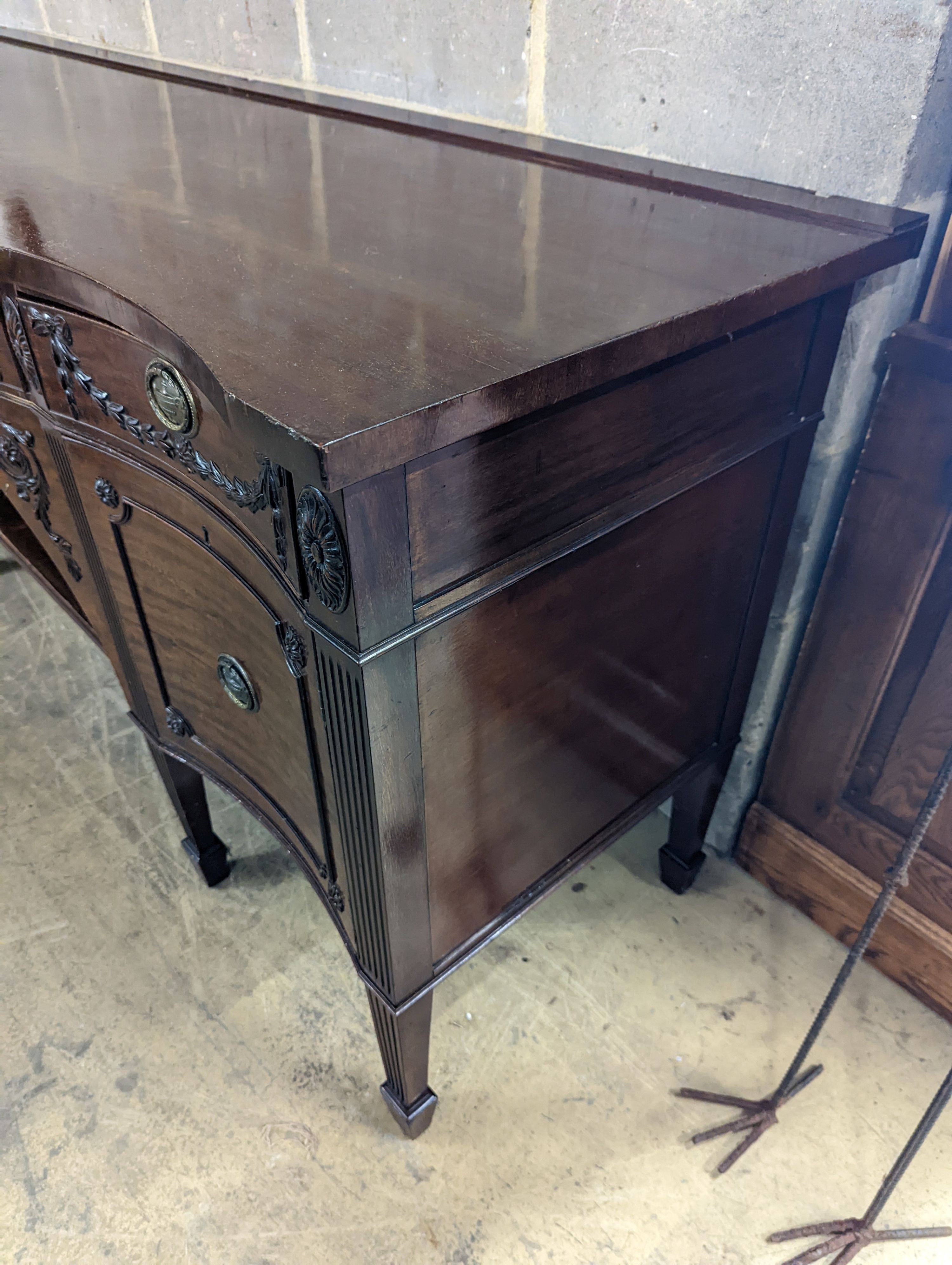 An early 20th century Adam design mahogany serpentine sideboard, length 214cm, depth 68cm, height 92cm